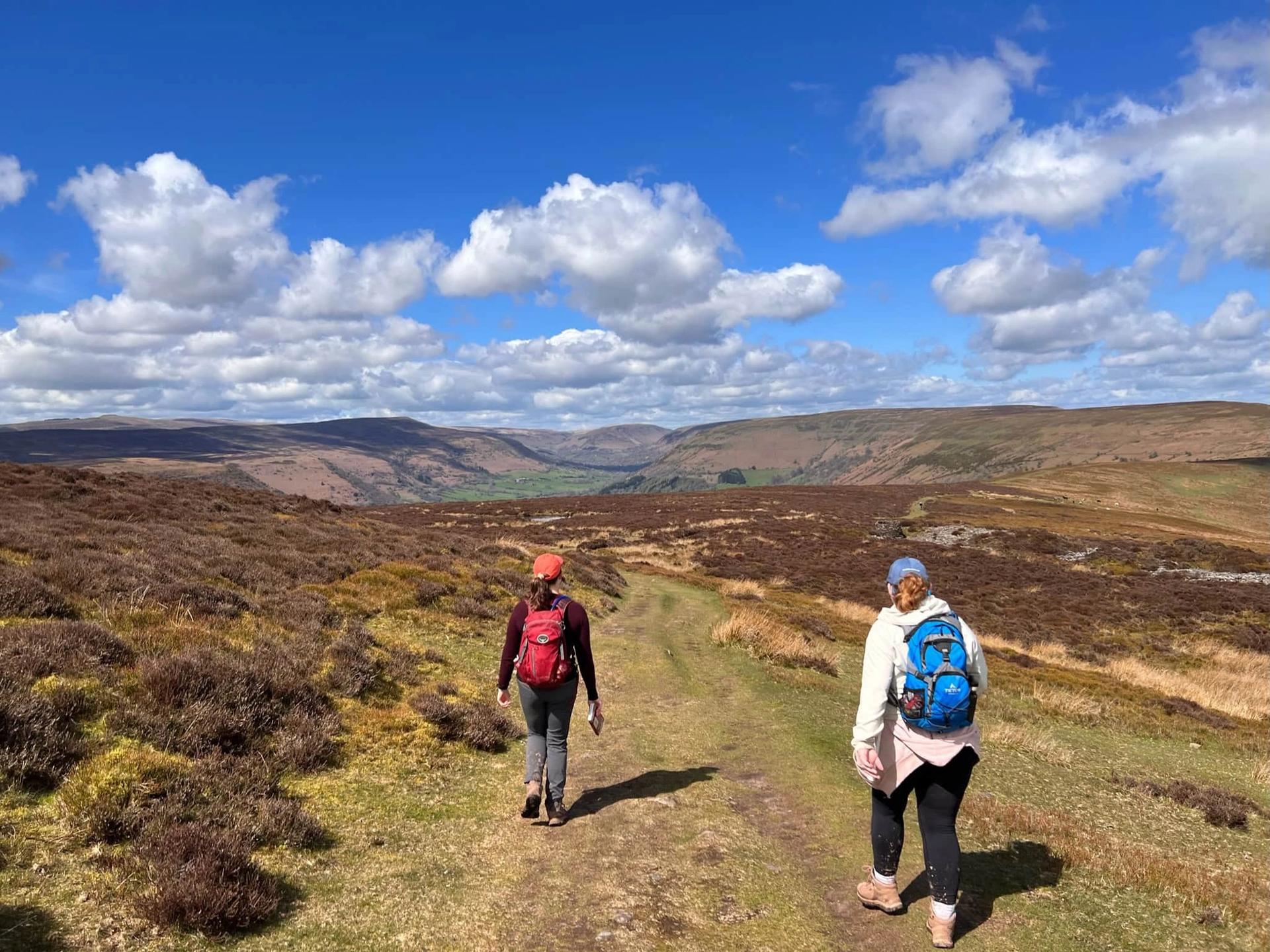 Walkers on the Offa’s Dyke Path crossing open moorland in the Welsh Marches