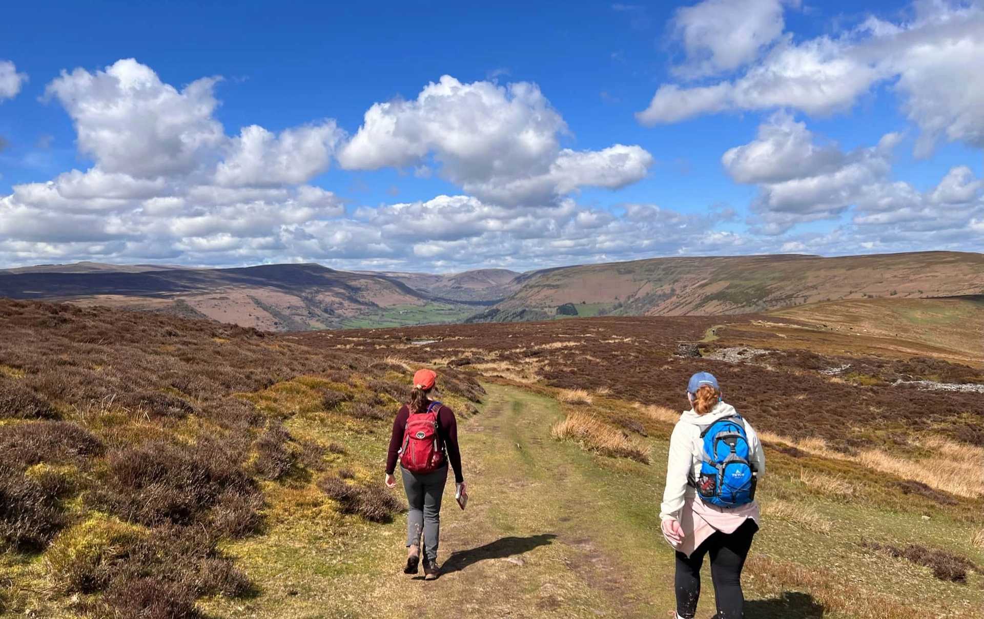 Walkers on the Offa’s Dyke Path crossing open moorland in the Welsh Marches