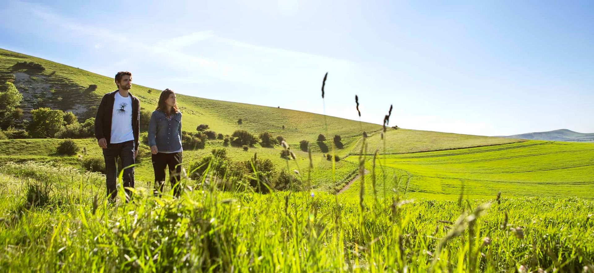 A couple walking through the rolling countryside