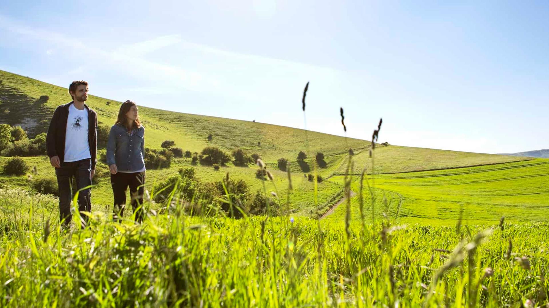 A couple walking through the rolling countryside