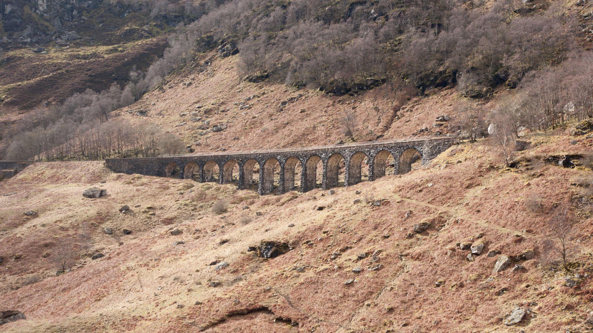 Old railway viaduct crossing a wooded Highland glen on the Rob Roy Way.