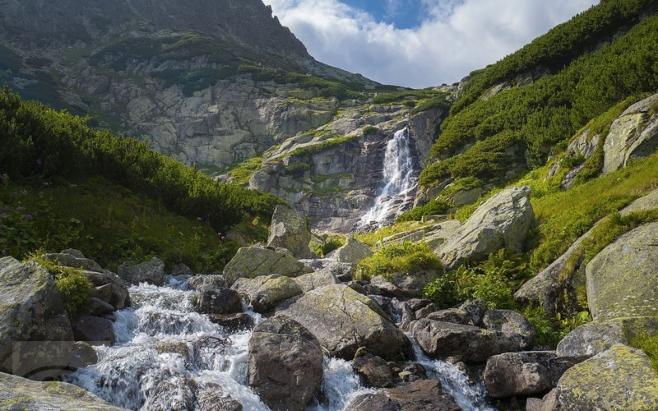Mountain waterfall and rocky stream in the High Tatras