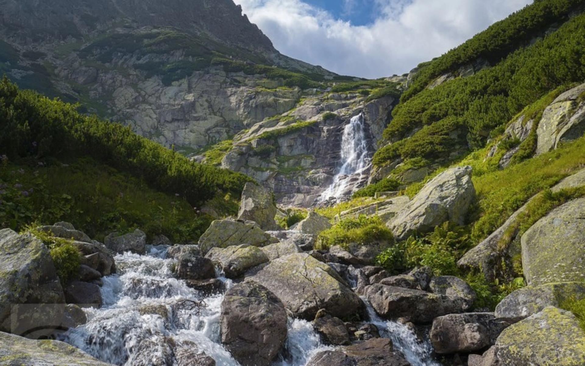 Mountain waterfall and rocky stream in the High Tatras