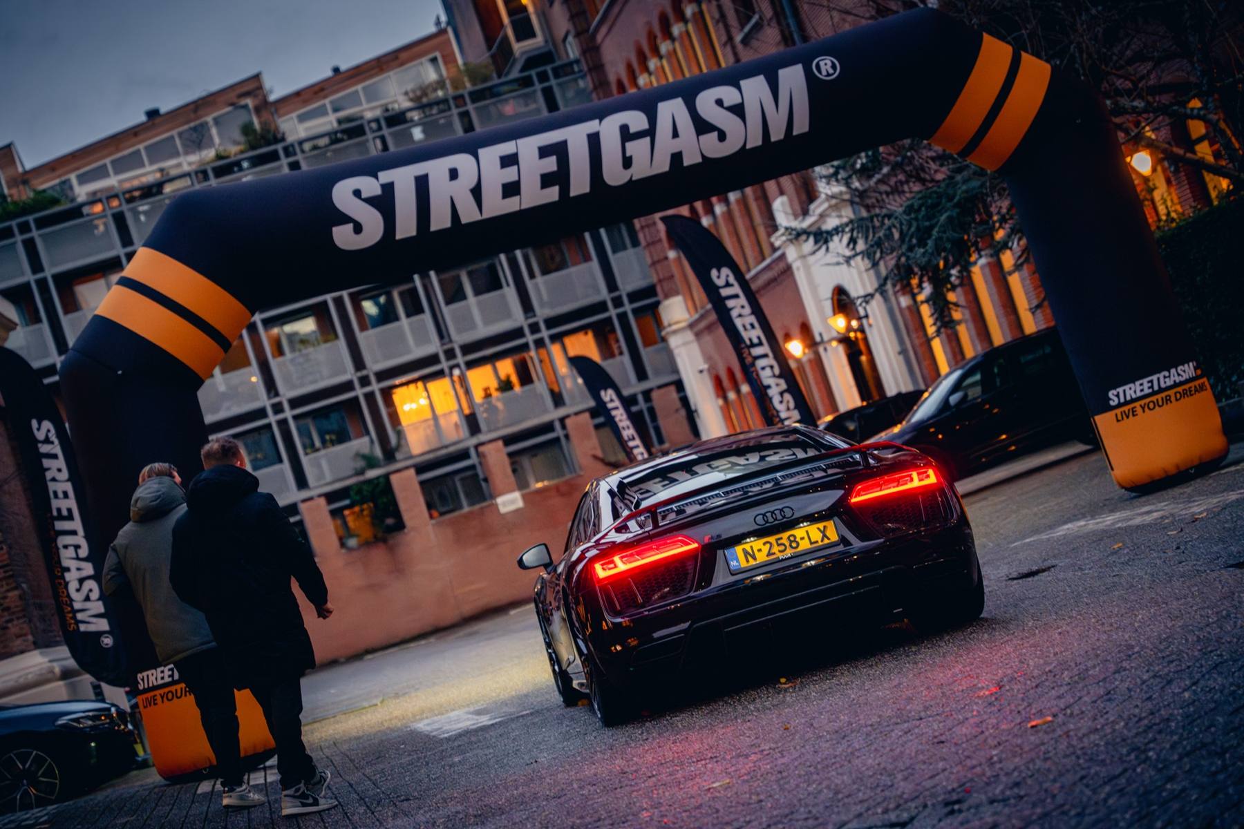 StreetGasm partner access beneath the illuminated arch during a GASSAN Watch Night.