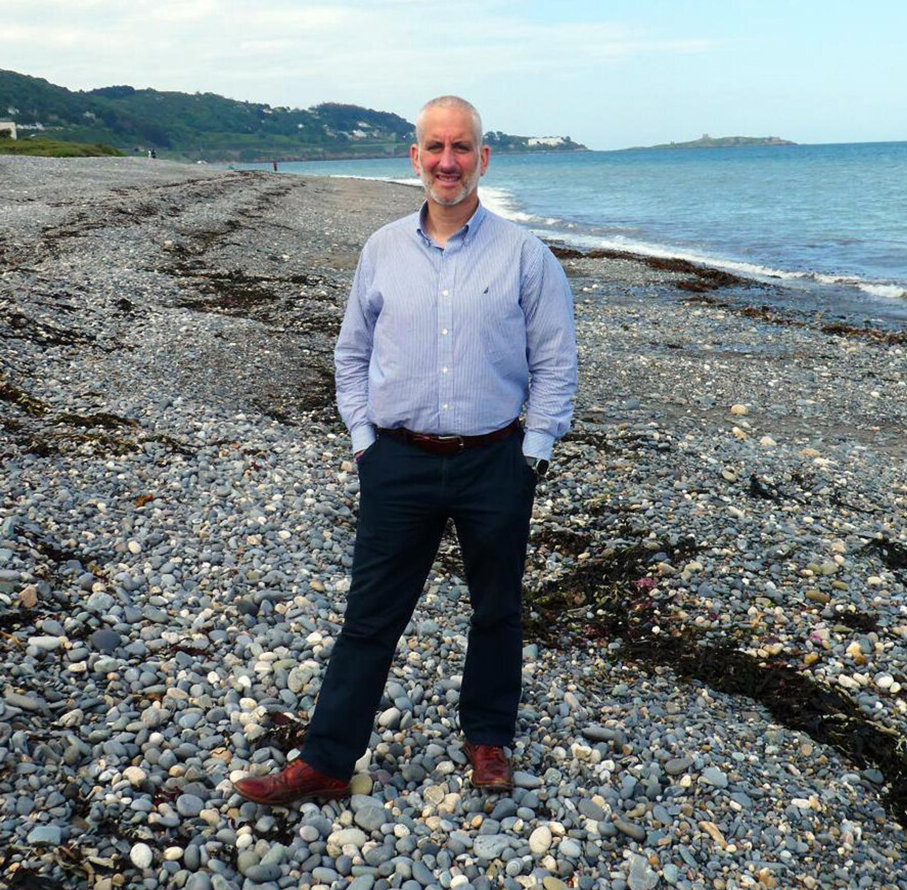 John standing on a beach