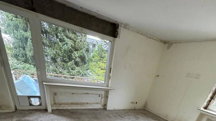 Entkernter Altbauraum mit Fensterbank und freigelegter Fensternische vor dem Rückbau