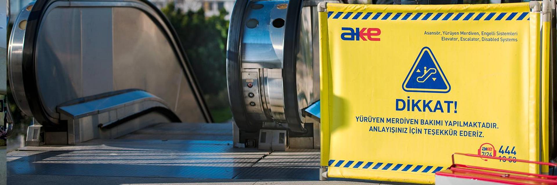 Escalator secured with a yellow AKE maintenance barrier during works