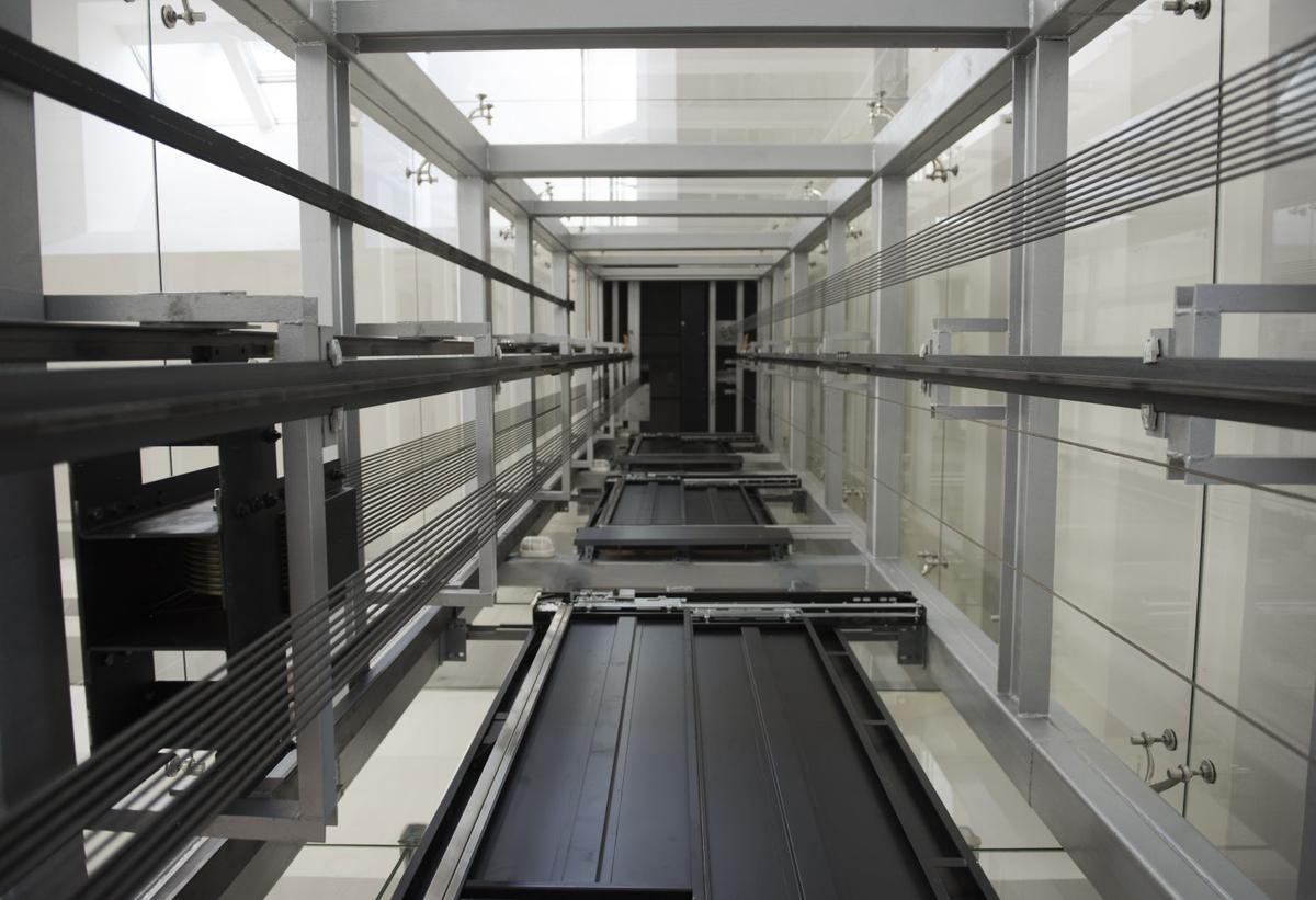 Steel structure, ropes and shaft equipment inside a glass elevator shaft