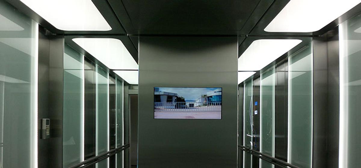 Interior of a spacious stainless steel stretcher elevator cabin