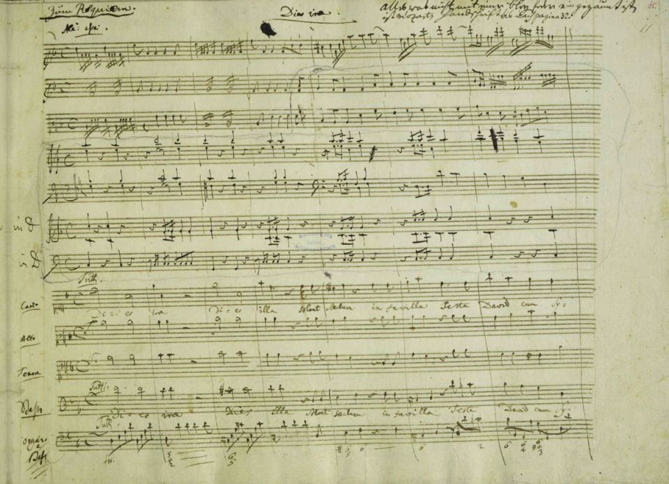 Opening of the Dies irae in Mozart's Requiem manuscript, with Eybler's orchestration added in pencil