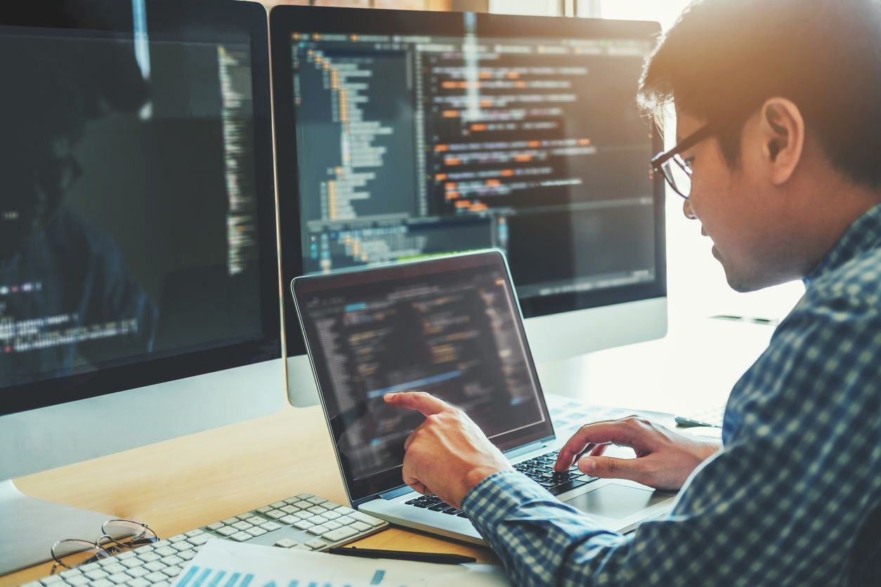 man coding on laptop - Hire App Developer