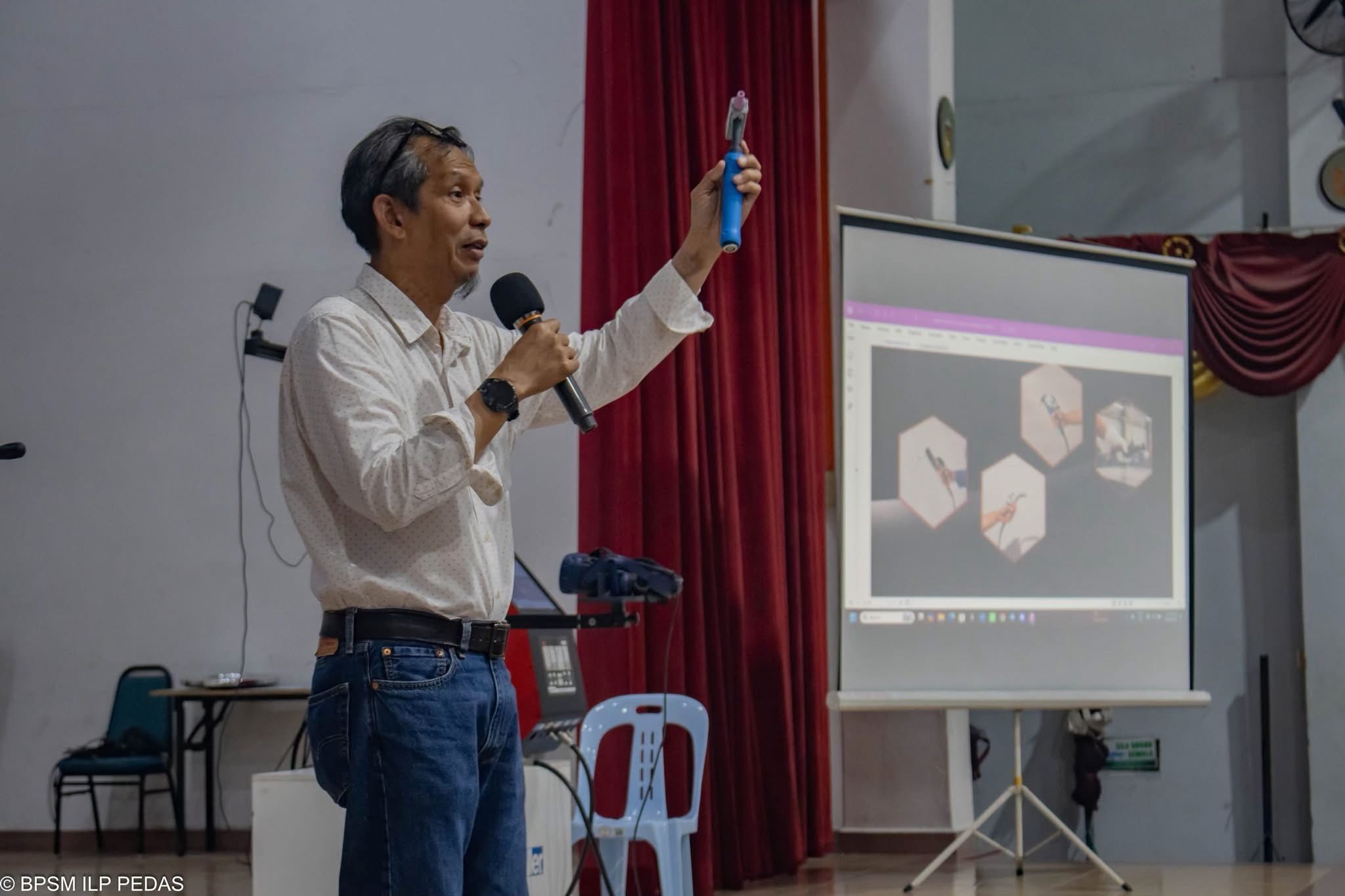 Presenter demonstrating a welding training tool during the ADTEC JTM Kampus Pedas seminar