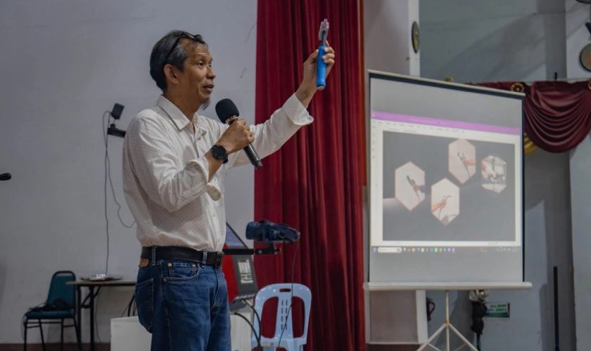 Presenter demonstrating a welding training tool during the ADTEC JTM Kampus Pedas seminar