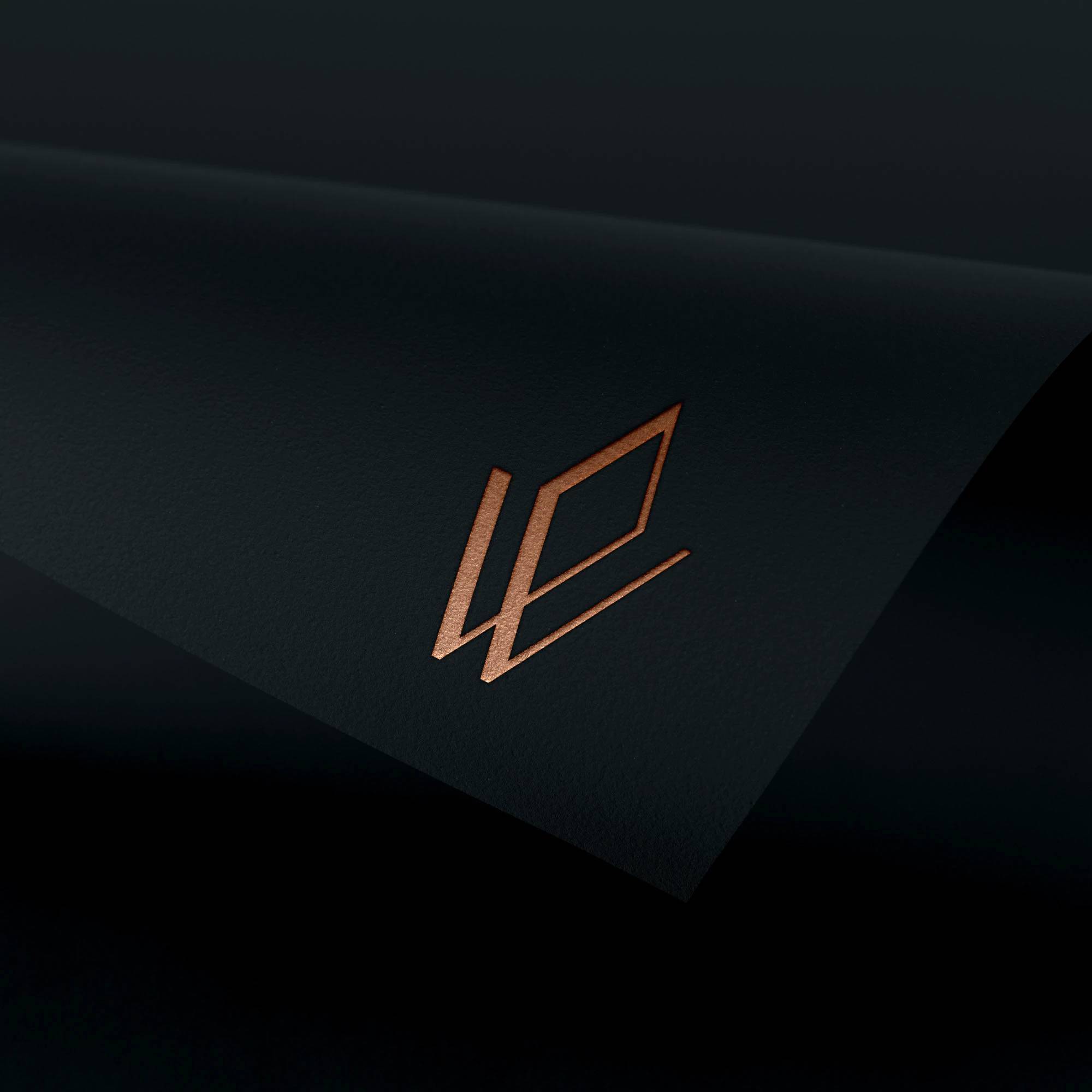 Copper Avion Wealth monogram embossed on a black presentation card.