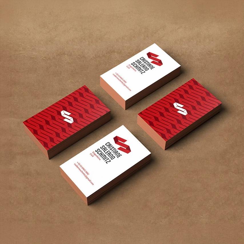 Red-and-white Cristiane Schmitz Engineering business cards with a repeating monogram pattern.