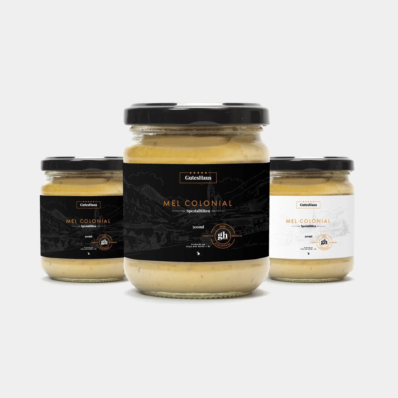 Three GutesHaus honey jars with black and white labels on a light background.