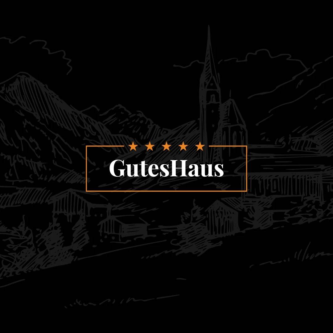 GutesHaus wordmark framed over a black Alpine village illustration.