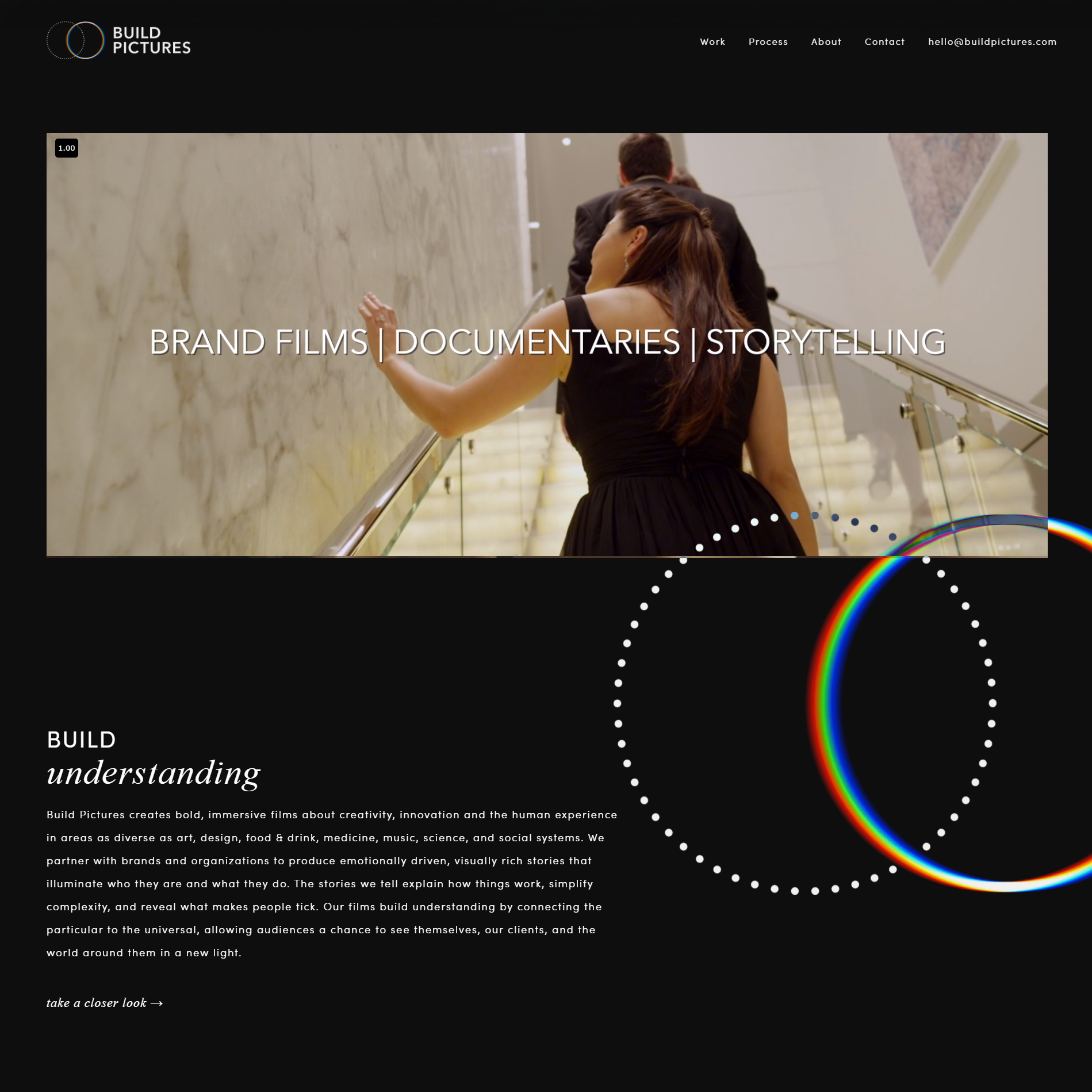Build Pictures homepage with a documentary film still, dark layout, and circular rainbow motif.