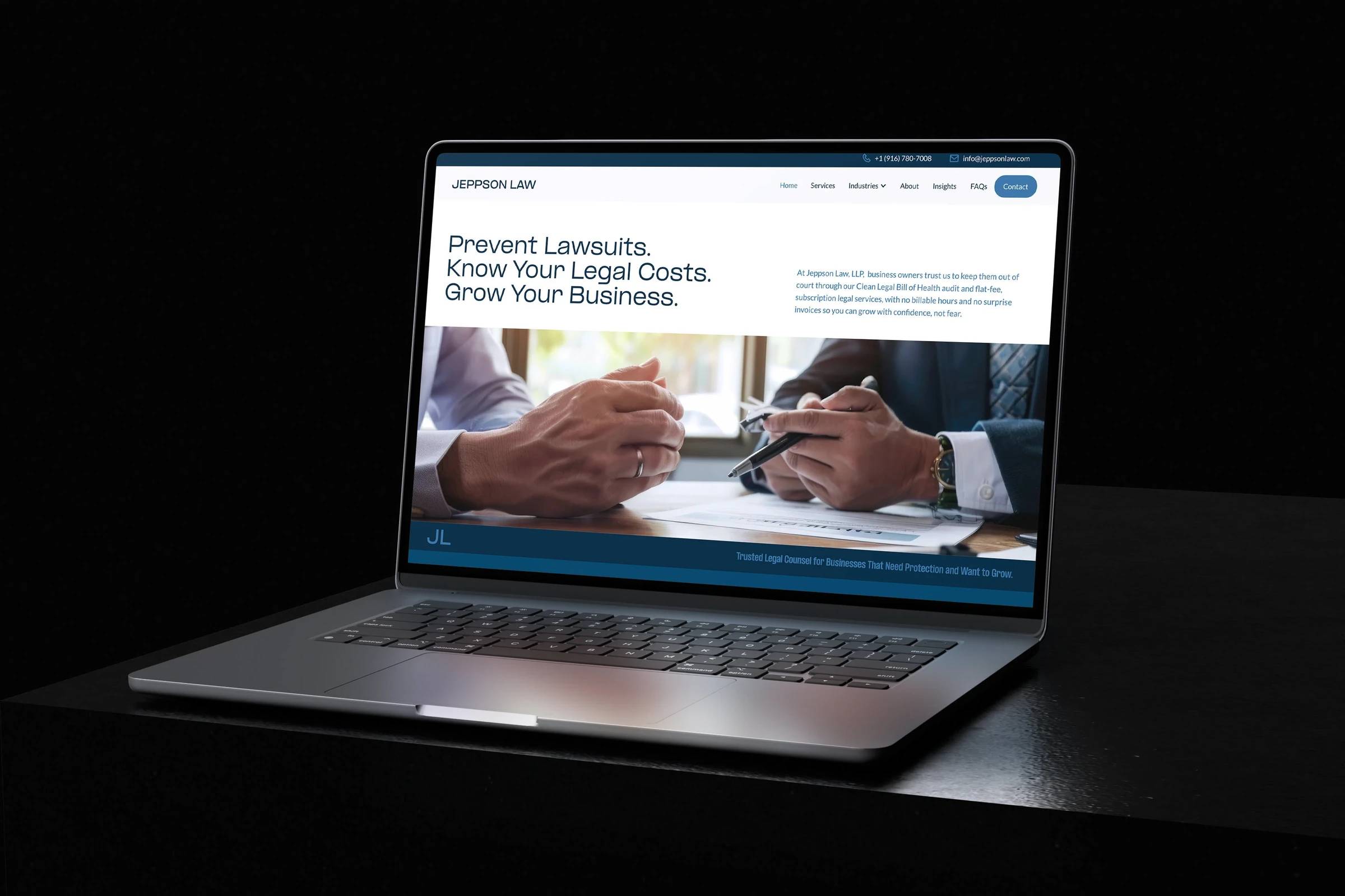 Jeppson Law website shown on a laptop in a dark office setting.