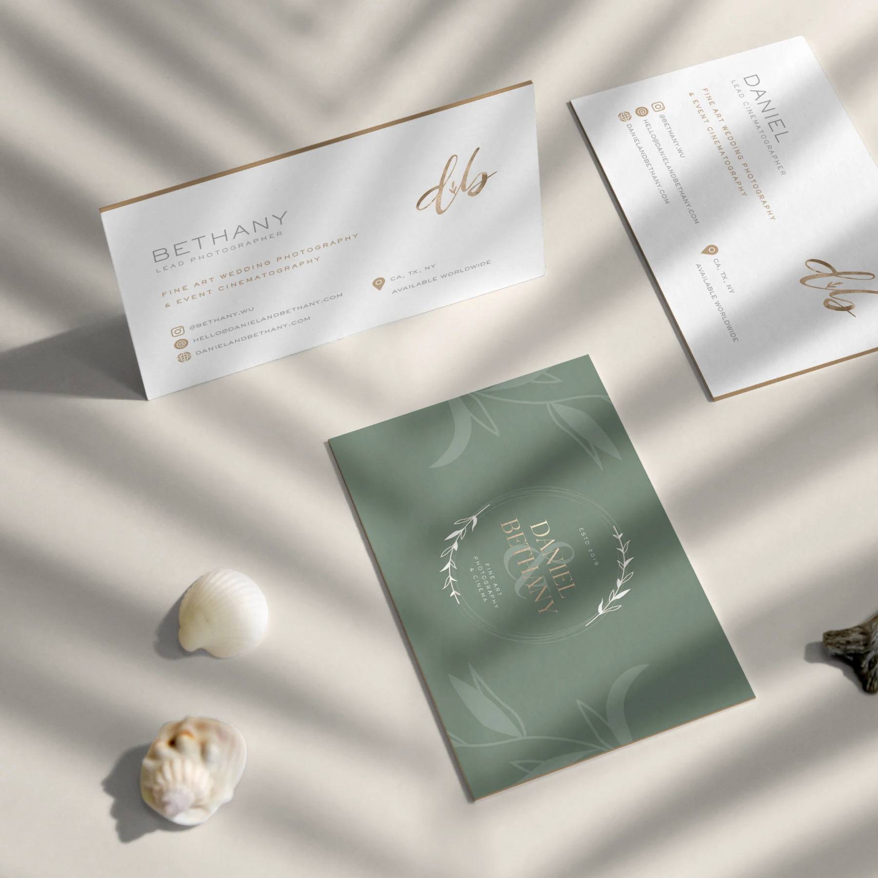 Daniel and Bethany business cards and green stationery arranged in soft window light.