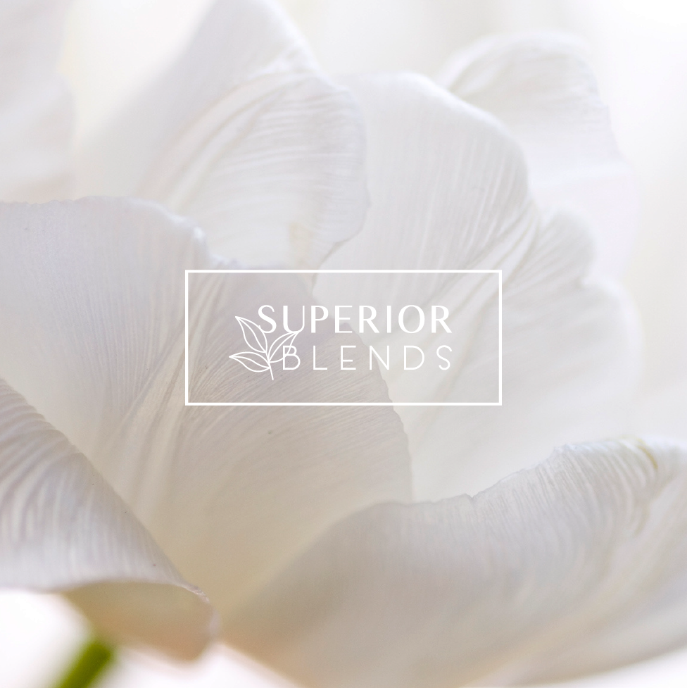 White Superior Blends framed wordmark over a soft white flower photograph.