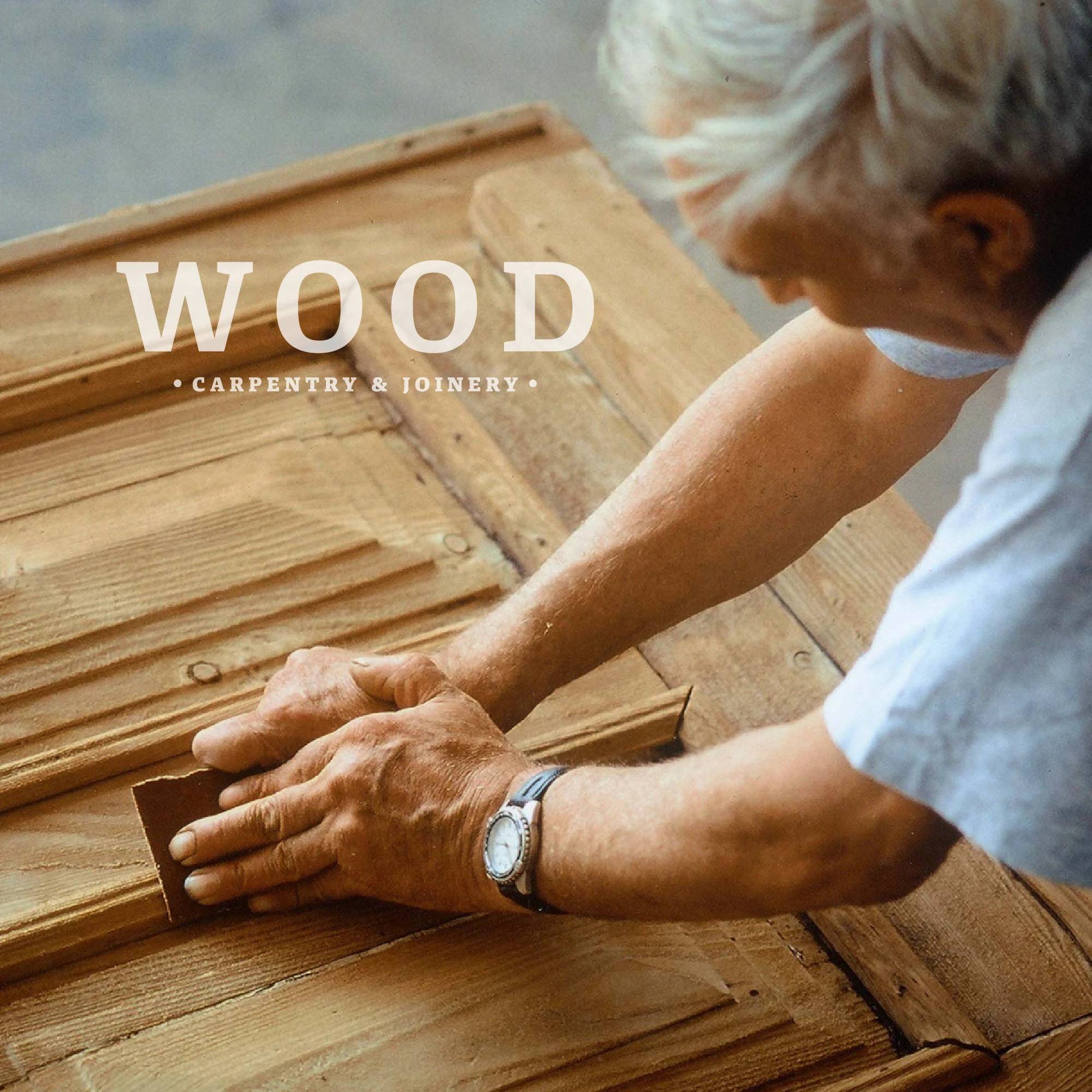 Carpenter sanding a wooden door beneath the Wood Carpentry and Joinery wordmark.
