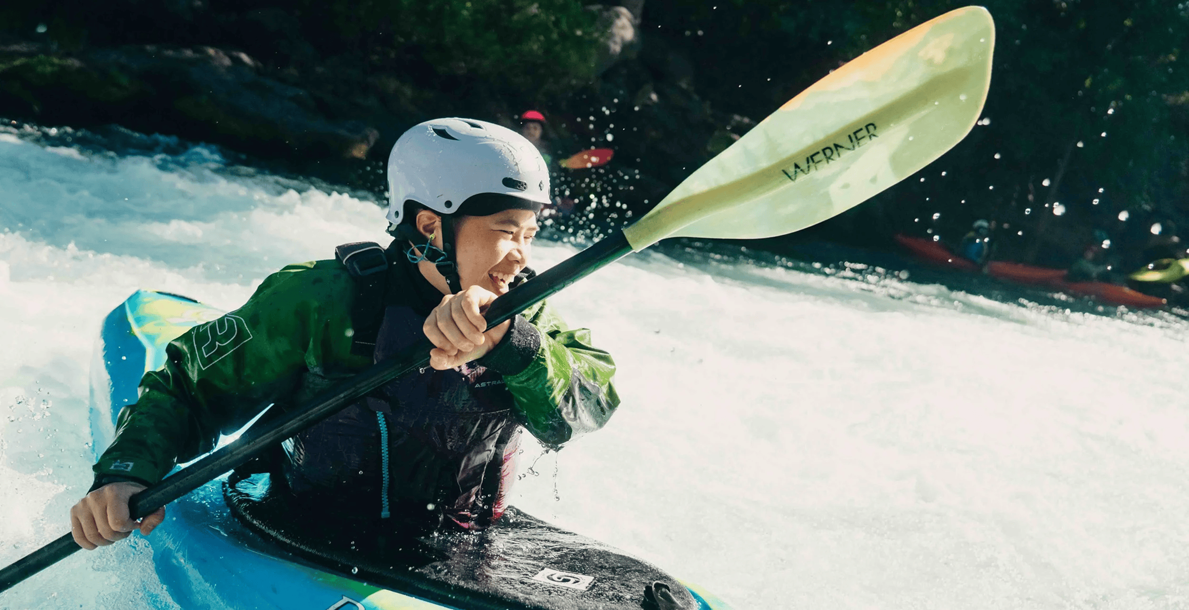 kayaker paddling down a river