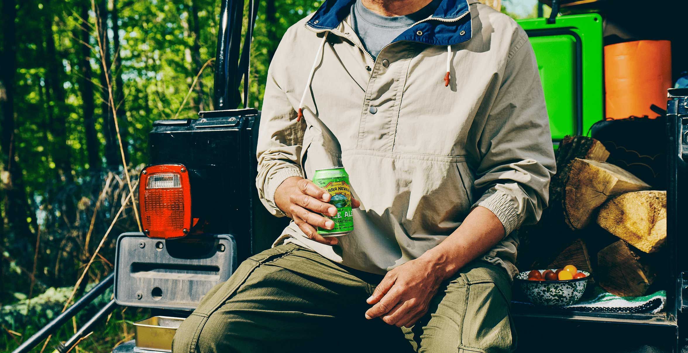 man drinking sierra nevada beer on the tailgate of a truck