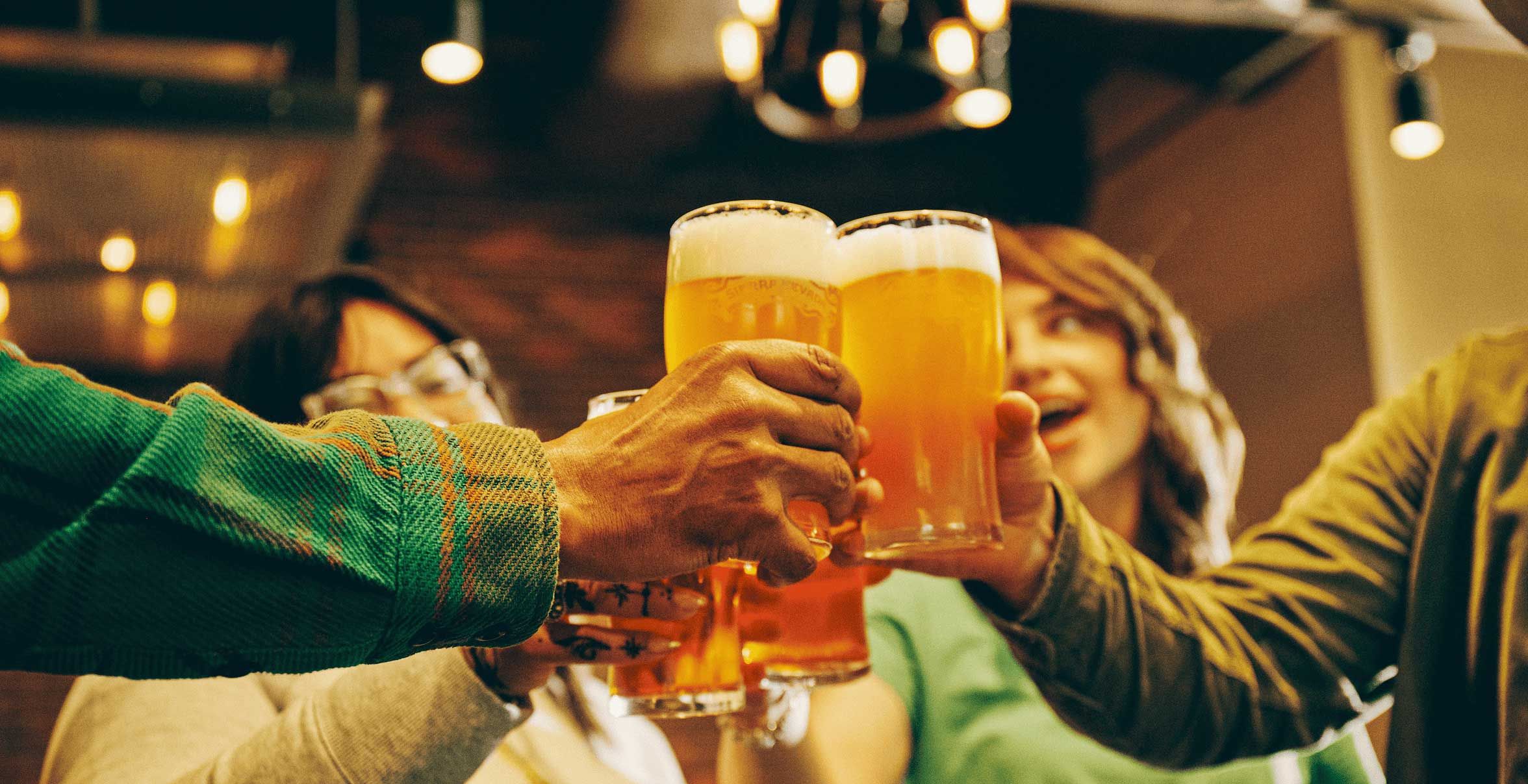 people toasting pint glasses full of sierra nevada beer