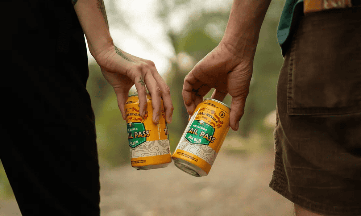 Two people with sierra nevada Trail Pass beers in hand
