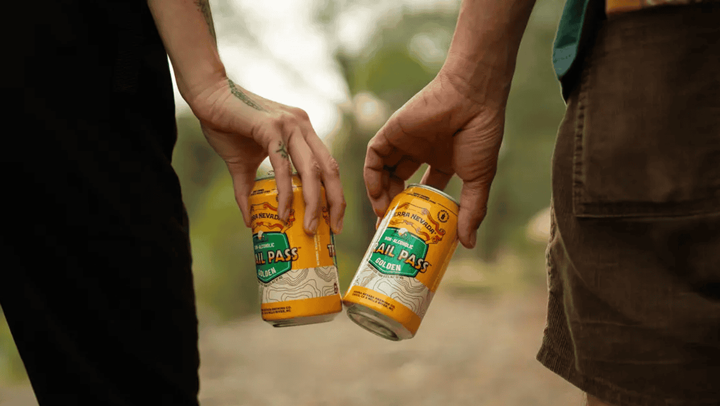 Two people with sierra nevada Trail Pass beers in hand
