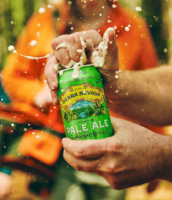 a person opening a sierra nevada beer