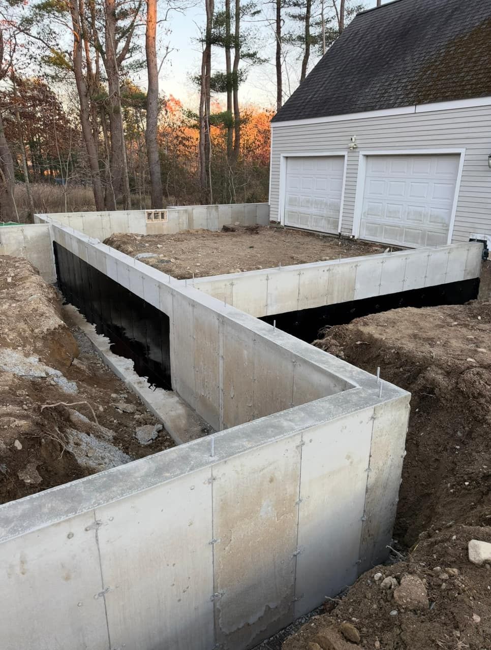 Precision-dug foundation hole graded and ready for footings on a residential build Legacy Excavation is an excavation company that provides foundation excavation and site prep in Plymouth, MA