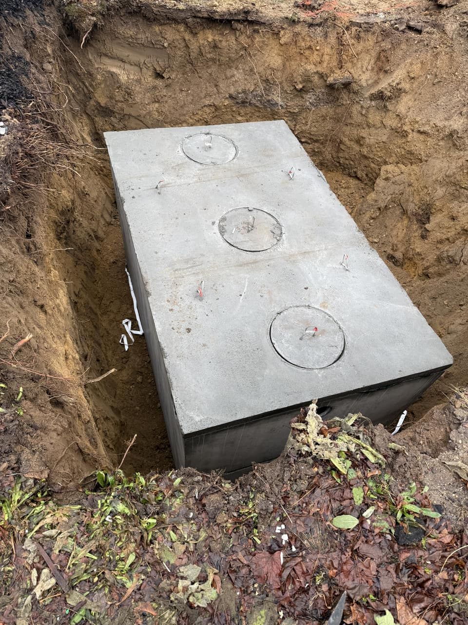 1,500-gallon concrete septic tank being set during a Title 5 system replacement Legacy Excavation is a septic system installer that provides Title 5 septic installations in Plymouth, MA