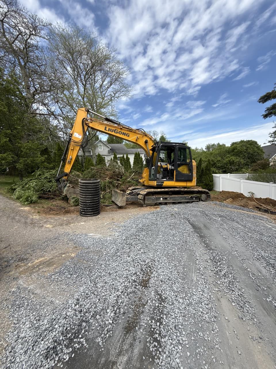 Excavator clearing brush and stumps to open a wooded residential lot for construction Legacy Excavation is a land clearing contractor that provides brush removal and site prep in Plymouth, MA