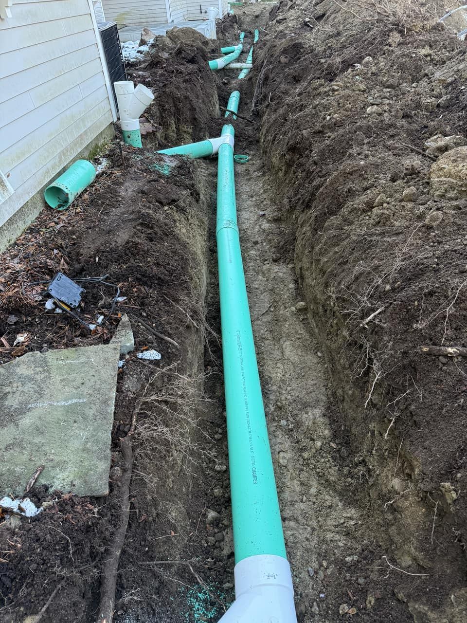 Buried roof drain line installed to carry storm water away from the house Legacy Excavation is an excavation company that handles wetland-buffer drainage permitting across Plymouth County, MA