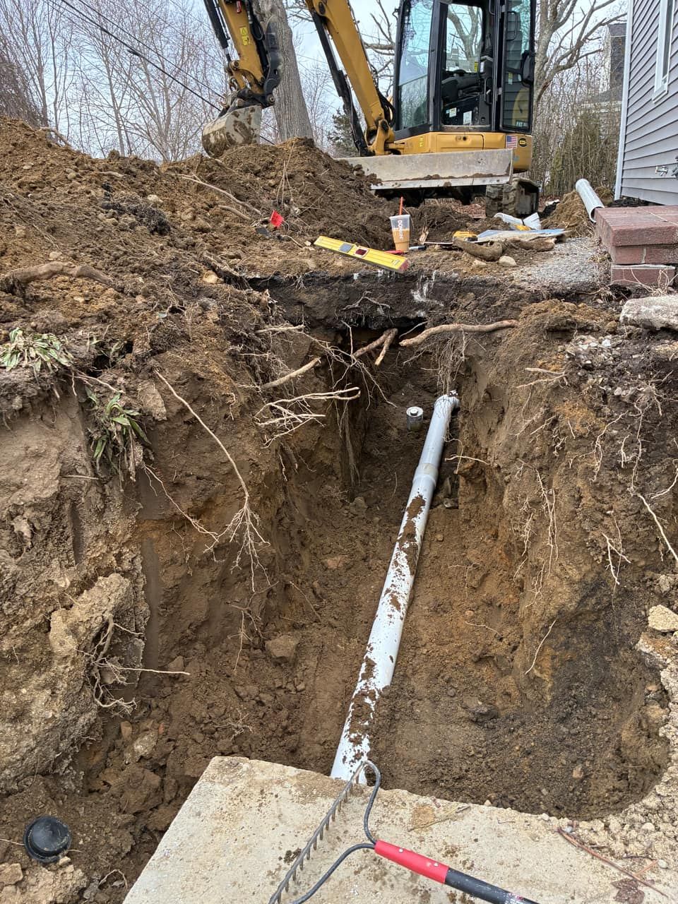 Main sewer line trenched to the septic tank during a repair for a home sale Legacy Excavation is an excavation contractor that provides failed Title 5 septic repairs for Southeastern MA home sellers