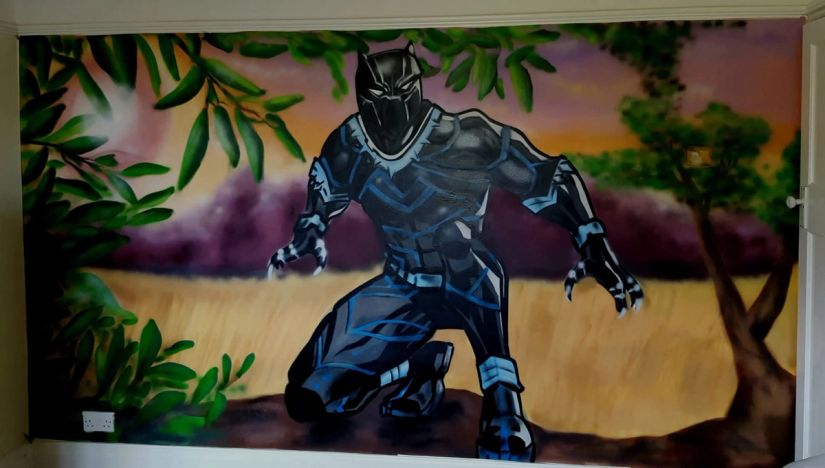 Black Panther superhero mural with a savanna sunset, custom spray-painted bedroom feature wall by Thomas Palaniuk