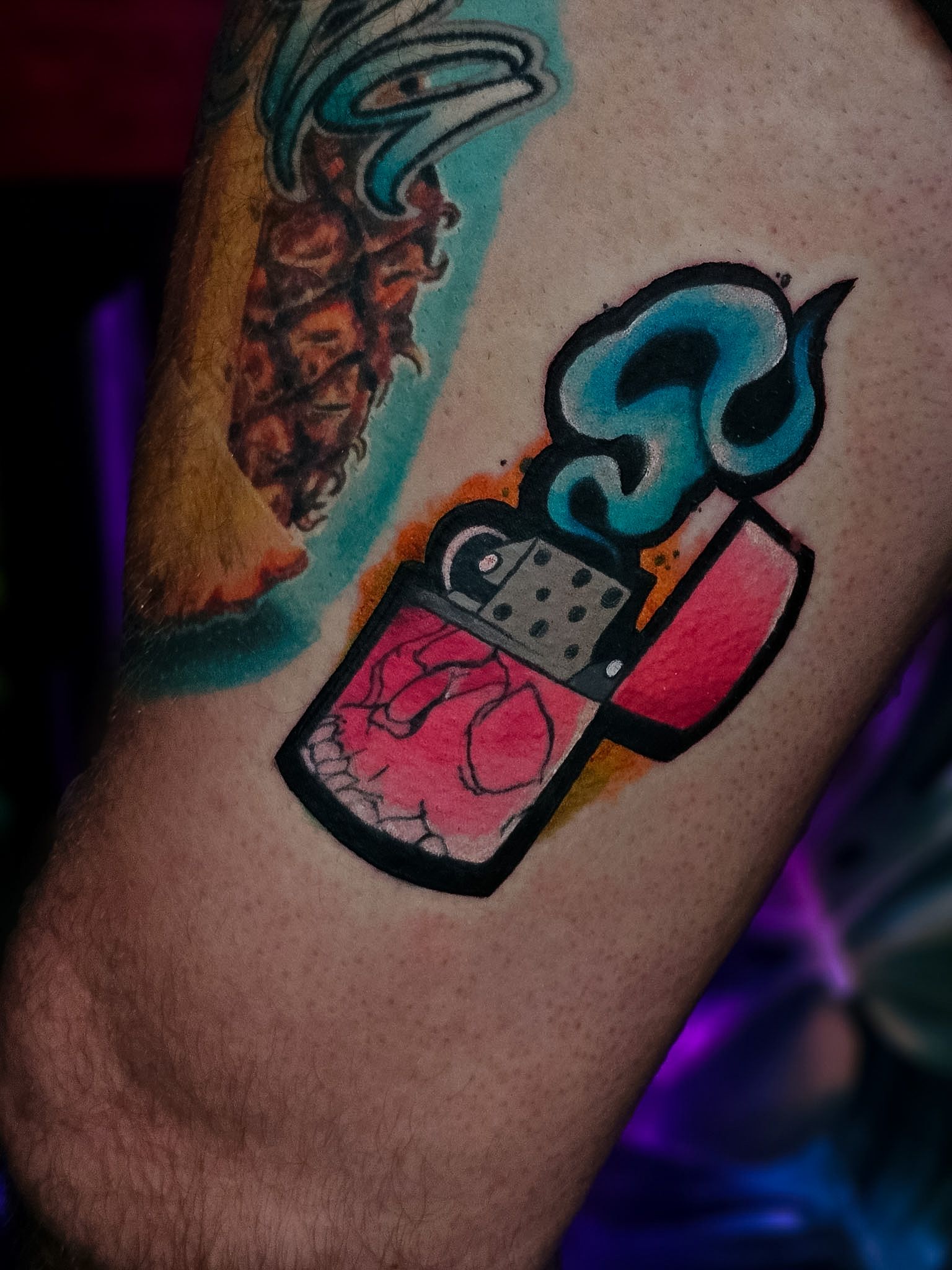 Bold colour lighter and pineapple tattoo, by Thomas Palaniuk, Aloha Tattoo Studio Gloucester