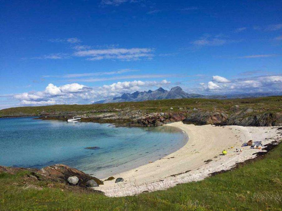 White beach along the coast of Helgeland with the Seven Sisters in the background