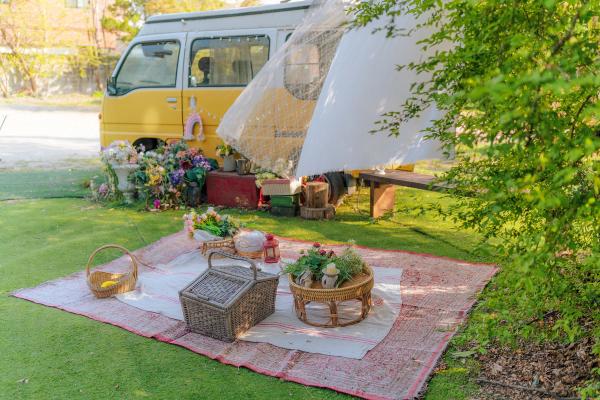 Picnic set up outside a campervan that brings the ultimate danish hygge
