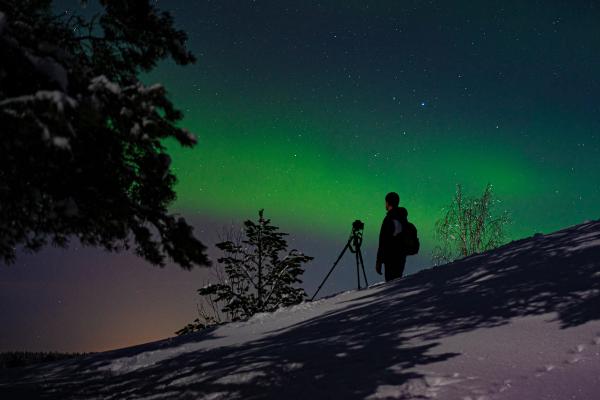 A guy looking up at the northern lights people who just noticed the lush northern lights