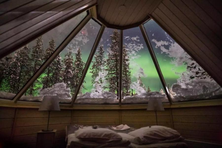 Aurora Borealis as seen from the inside of the glass roof of a cabin
