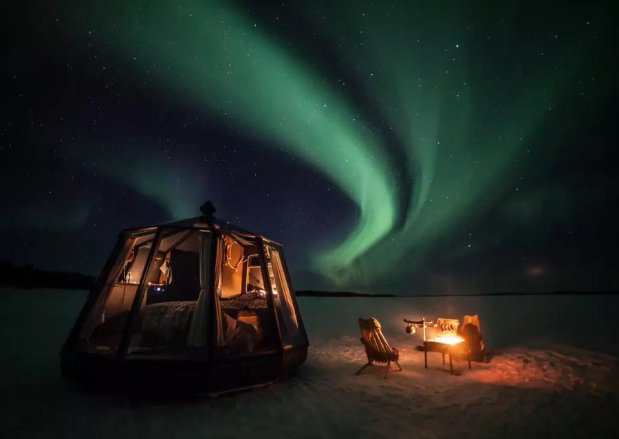 Northern lights over a luxury iglo on a ice covered lake in Jokkmokk, Sweden