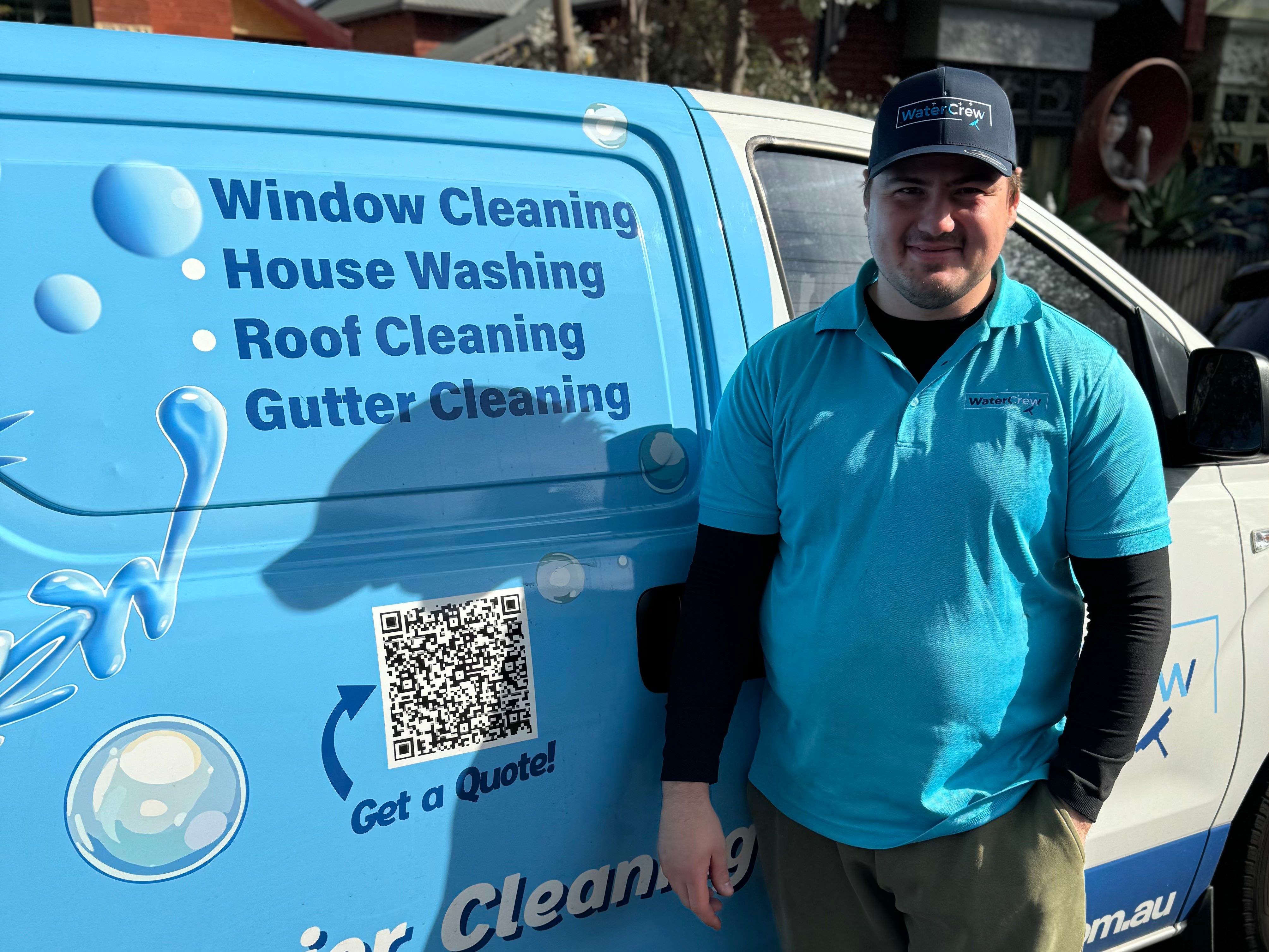 WaterCrew technician beside the signwritten van on a St Kilda East job