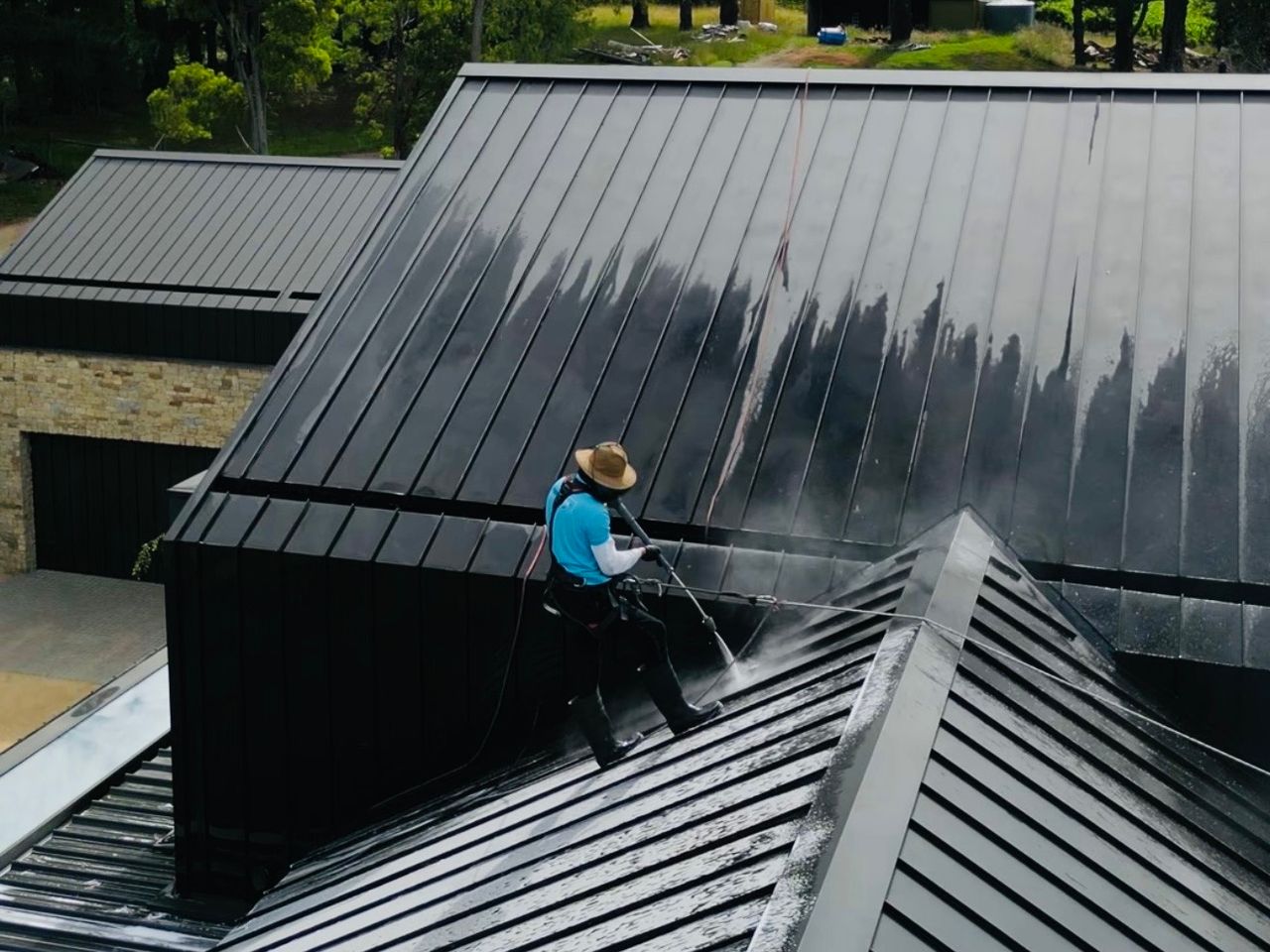 WaterCrew technician pressure cleaning a concrete driveway in Melbourne