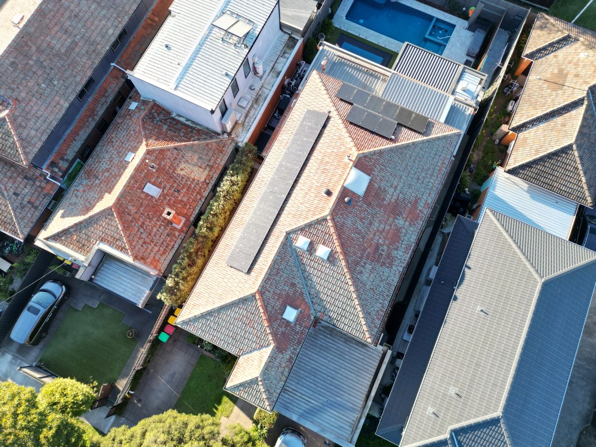 Aerial of a terracotta roof on Rockbrook Road, greyed by growth across the tiles