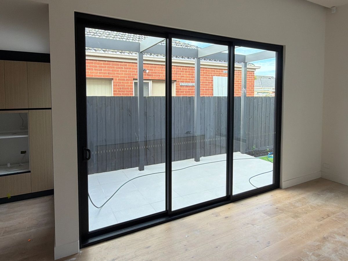 The same Kaniva Court windows and sliding channels cleared of adhesive, labels and construction grit