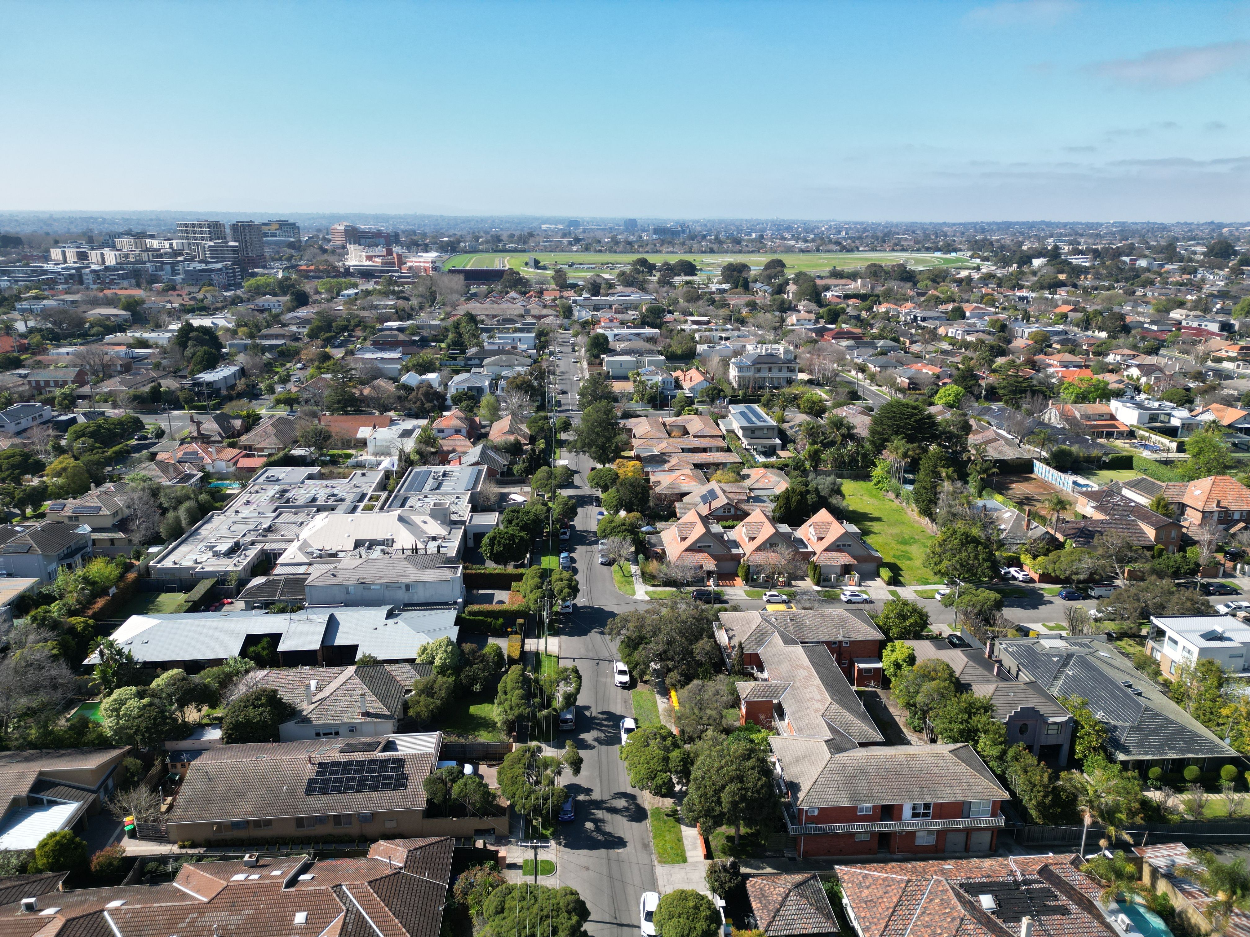 Aerial over Caulfield North with the racecourse track and open turf on the horizon