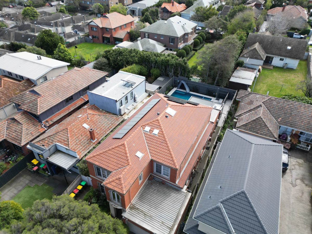 The same Rockbrook Road roof after cleaning, orange terracotta clear on every slope